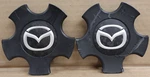 Pair Of Oem Used Mazda Center Caps P/n G22BV3815. Price: $14.95.