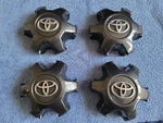 Set Of Oem 2016-2023 Toyota Tacoma Dark Charcoal Center Caps P/n 4260B-04050 Used. Price: $80.00.