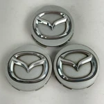 Mazda Center Set Of 3 Oem Silver Wheel Hubcaps DB2874 Genuine Used. Price: $26.99.