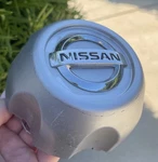 Nissan Frontier / Xterra Wheel Center Cap 40315-1Z800 Chrome Emblem 1998-2004 Used. Price: $49.00.