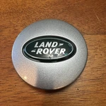 Land Rover Oem Wheel Center Cap Silver Finish Gold Letters Green RRJ500030XXX Used. Price: $12.00.